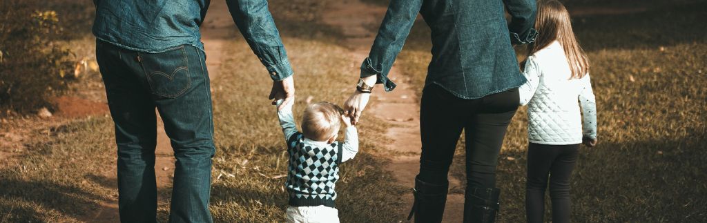 A family walking hand in hand on a dirt path, symbolizing the legal protection and guidance a family lawyer in Thailand can provide.