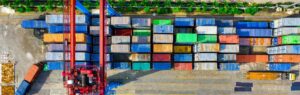 Aerial view of shipping containers and a crane, symbolizing import in Thailand