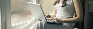 Femme travaillant sur son ordinateur portable depuis chez elle, représentant une entreprise en ligne en Thaïlande