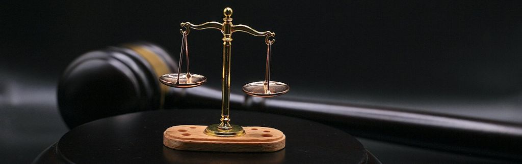 Golden justice scale on a desk symbolizing the legal framework of Company Law in Thailand