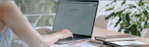 Person typing on laptop researching boi 2025 investment regulations in Thailand