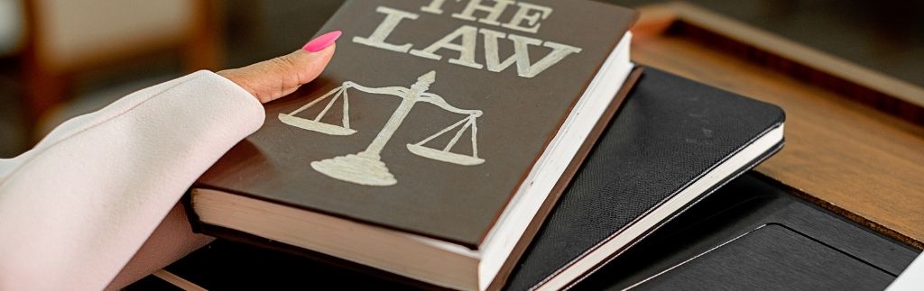 Law book with scales of justice – symbol of competition law in Thailand