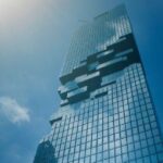 Modern glass skyscrapers under the Bangkok sun, symbolizing Thailand’s growing innovation hub and ideal environment for start-up Thailand investors.