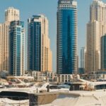 Яхты у небоскрёбов на фоне Дубай Марина, иллюстрирующие уровень инфраструктуры, которую предлагает свободная экономическая зона Дубая.