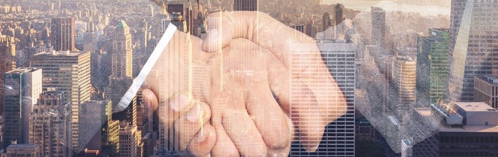 Handshake over a city skyline symbolizing the business partnership enabled by the Treaty of Amity between the U.S. and Thailand.