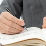 Lawyer reviewing legal documents with gavel and scales of justice on desk, illustrating consumer protection Thailand and regulatory compliance.