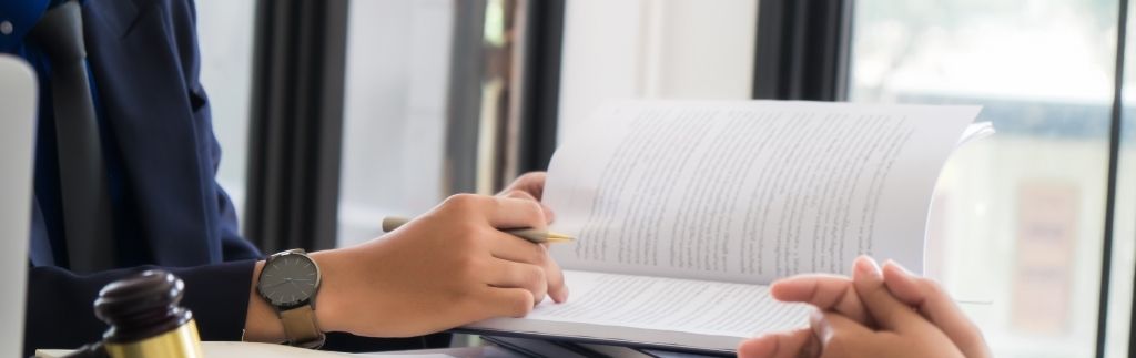 Lawyer reviewing legal documents with a client, illustrating the risks of buying property in Thailand