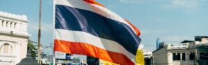 Thailand flag in an urban setting, symbolizing the ongoing Thailand Cambodia War.
