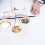 Legal consultation about foreigner land ownership in Thailand with scales of justice and lawyer